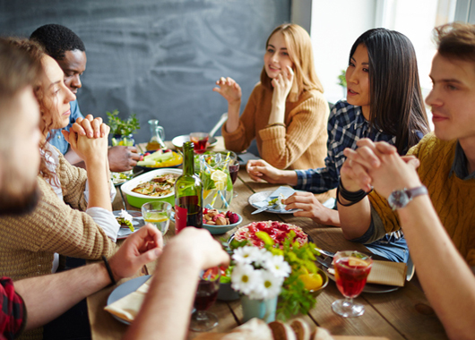 Group of intercultural friends having Thanksgiving dinner