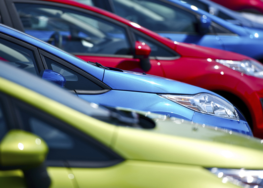 Close up shot of multiple cars on a car lot.