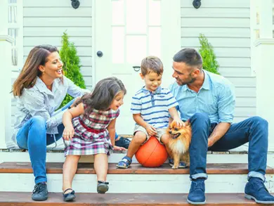 Family sitting on their front porch