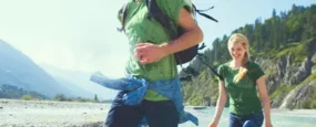 couple running through water on a hike