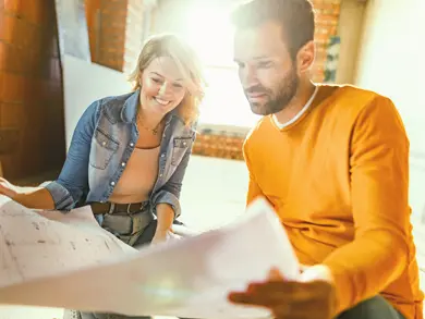 Couple reading floor plans together