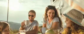 Family eating dinner outside their RV