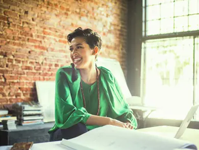 Women smiling while sitting at table