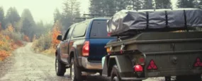 Truck pulling a trailer in the rain