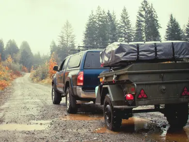 Truck pulling a trailer in the rain