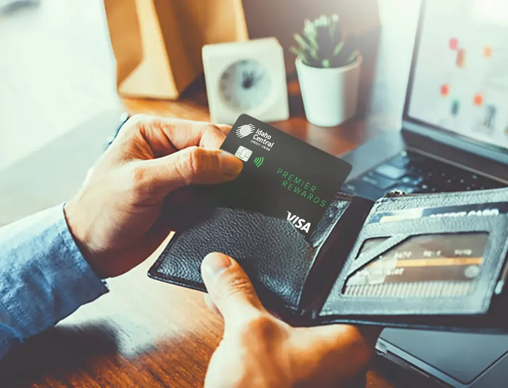 Man holding wallet and ICCU Credit Card