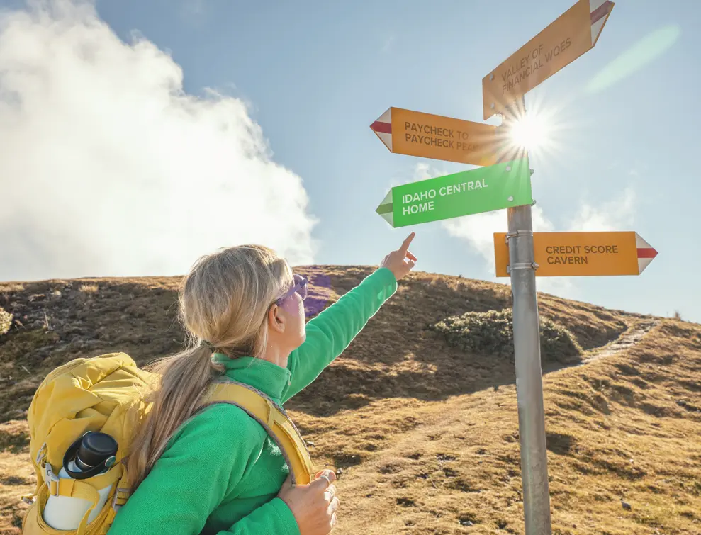 Women hiking and looking at signs