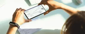 Person taking a picture of their check with their phone