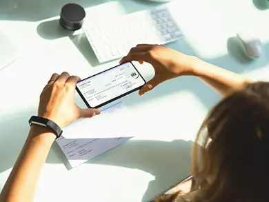 Person taking a picture of their check with their phone