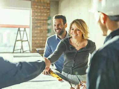 People shaking hands in a room being renovated