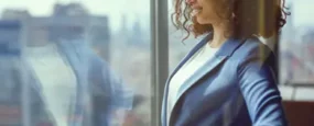 Business women staring out a window