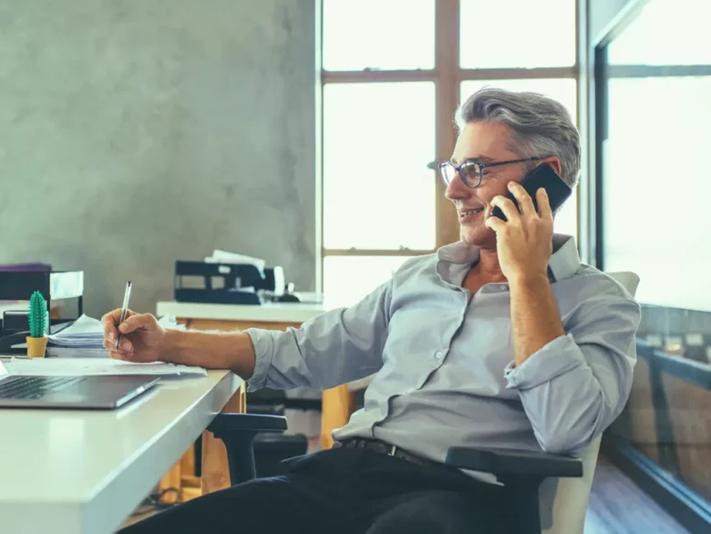 Man on the phone at his desk