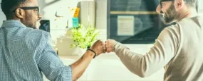 Co-workers giving a fist bump