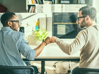 Co-workers giving a fist bump