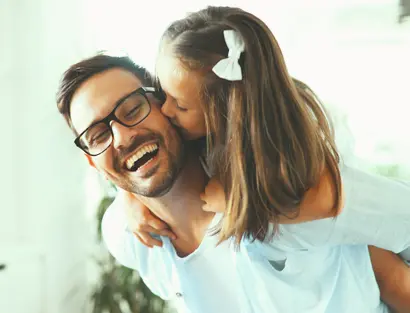 daughter kissing her fathers cheek