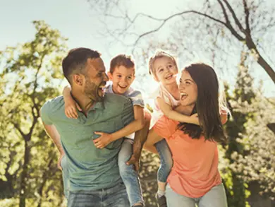 Family smiling outside