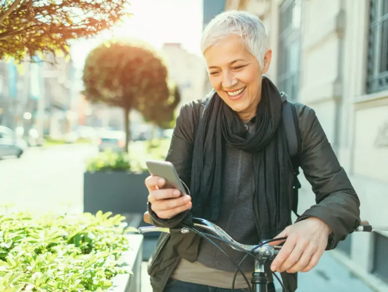 Women checking her phone while on her bike