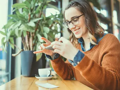 women taking a picture with her phone