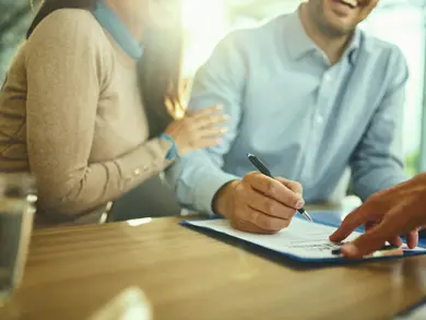 couple signing paperwork