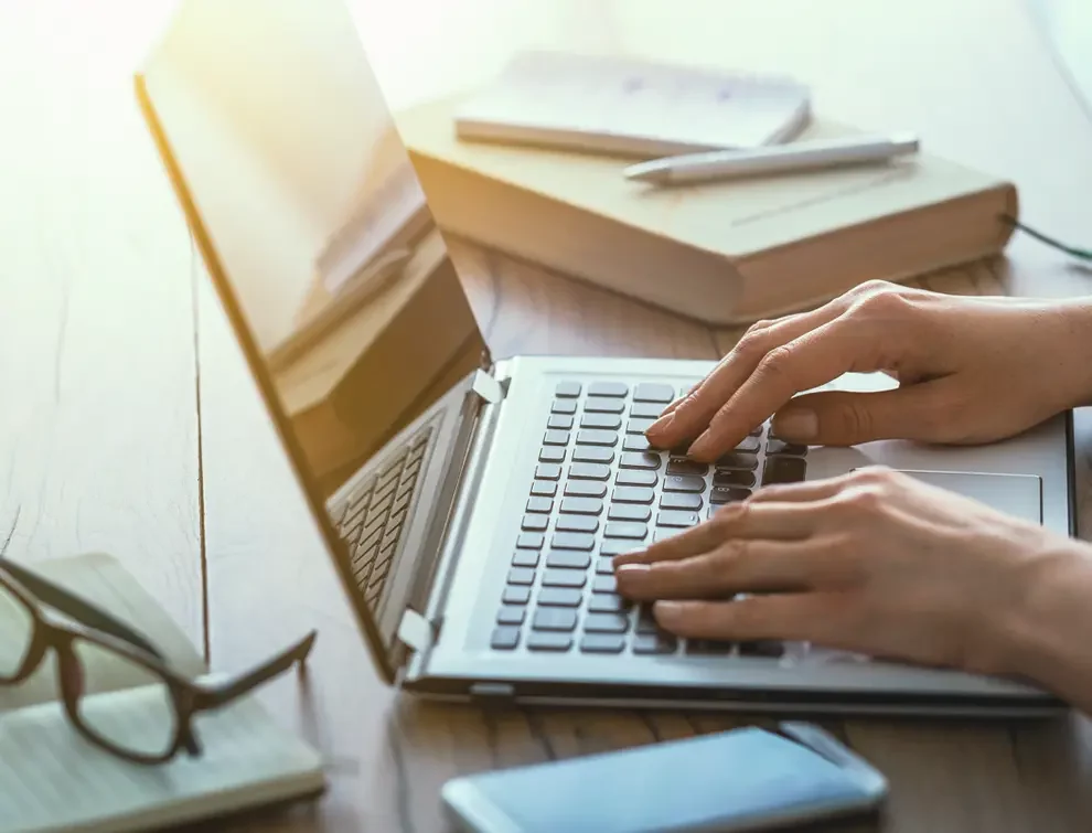 person typing on their computer