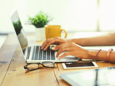 women typing on her computer