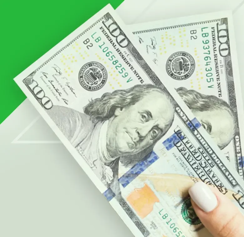 someone holding 200 dollars