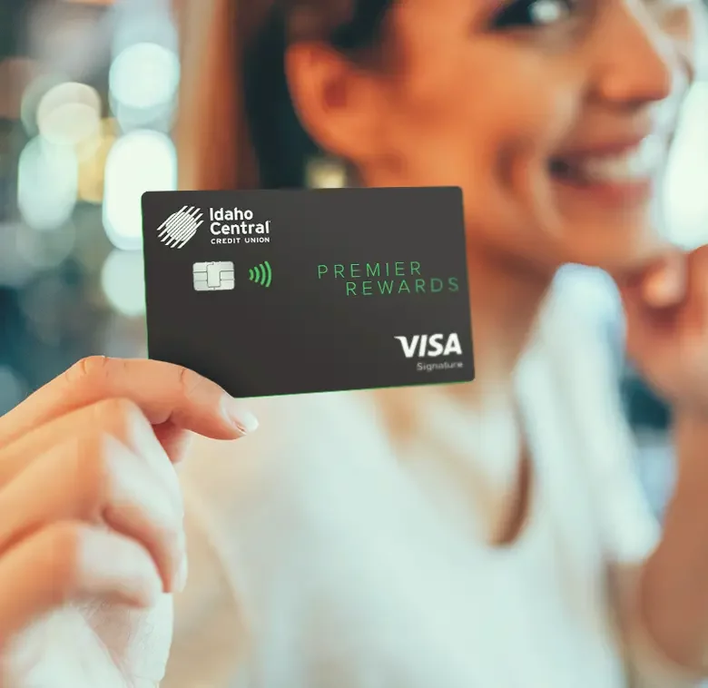 women holding an ICCU credit card