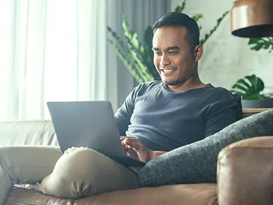 man on his computer smiling