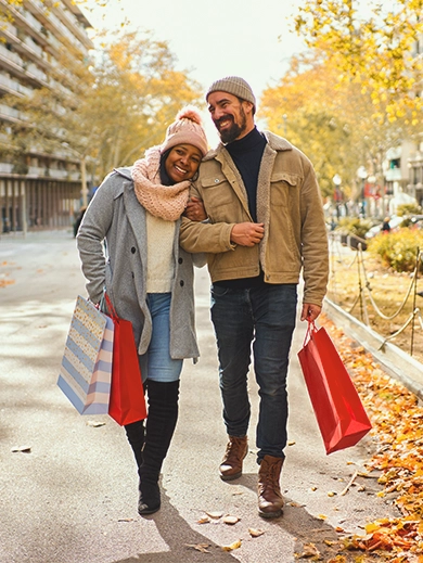 A couple walking together holding shopping bags