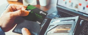 Man holding wallet and ICCU Credit Card