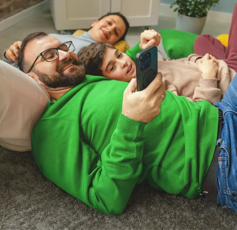 Family of three laying on their home floor