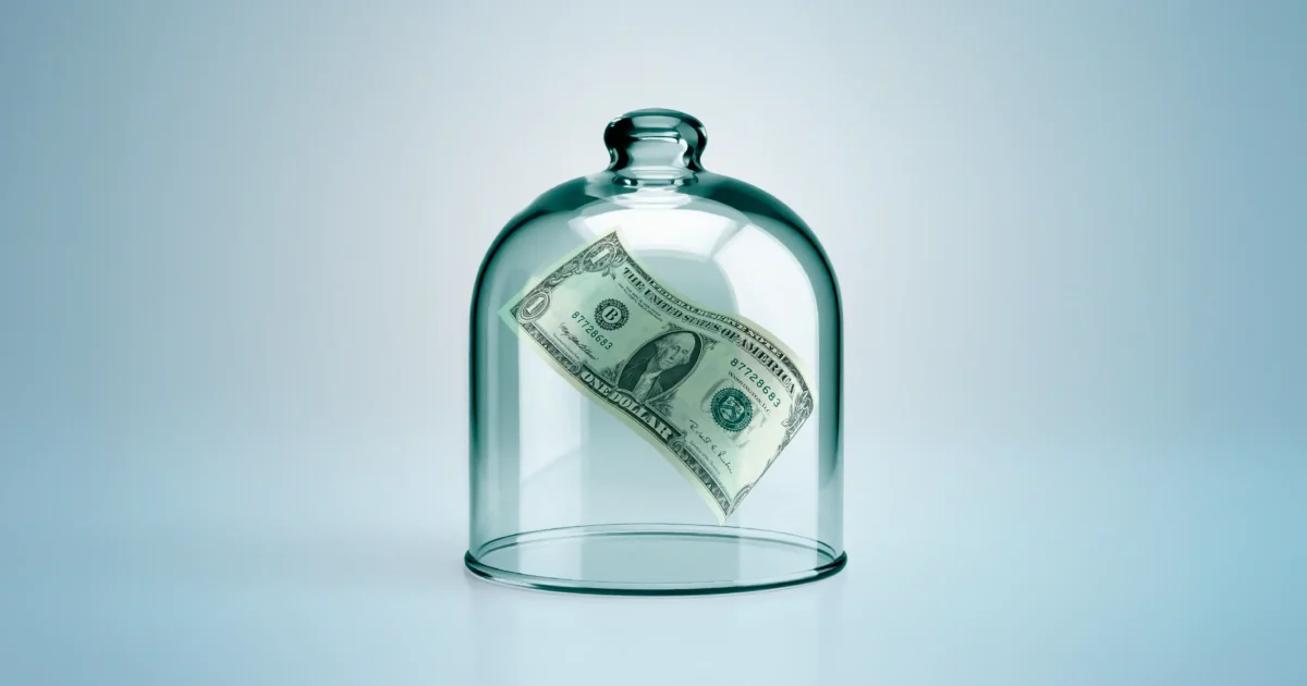 One-dollar bill enclosed under a glass dome symbolizing financial protection and security.